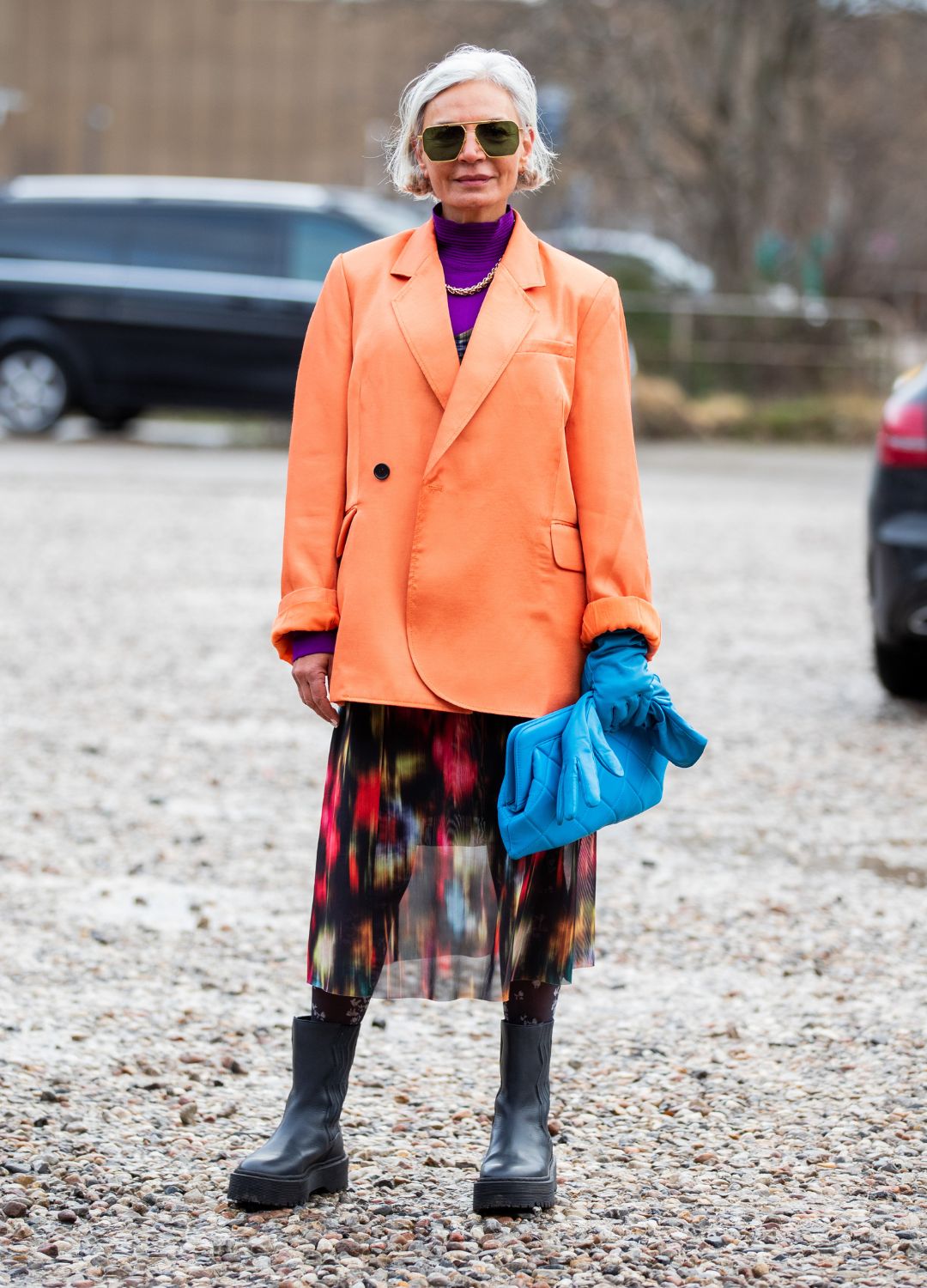 Grece Ghanem is seen wearing orange blazer, purple turtleneck, blue clutch, gloves outside Baum und Pferdgarten during Copenhagen Fashion Week Autumn/Winter 2020 Day 3 on January 30, 2020 in Copenhagen, Denmark.