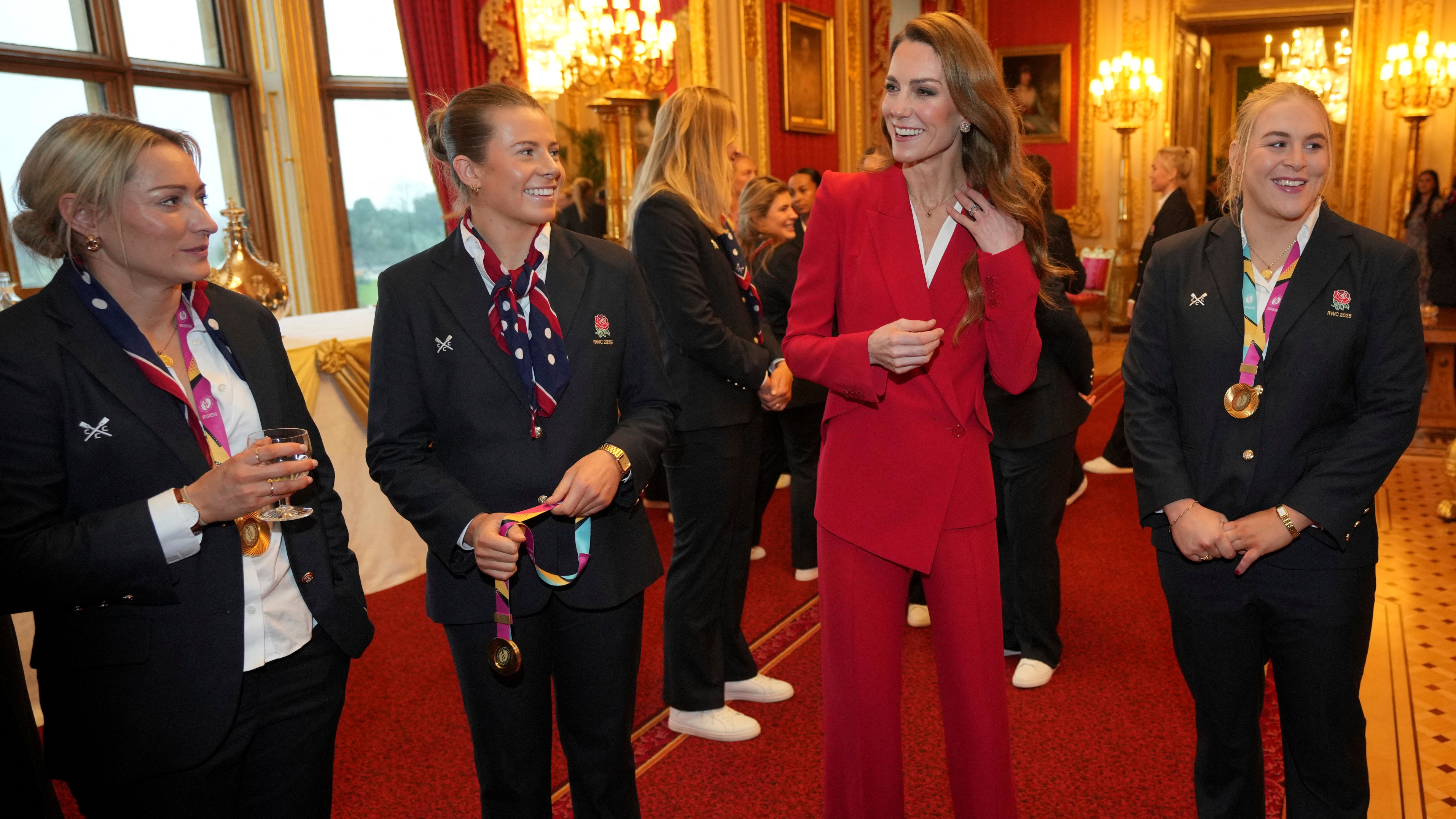 Catherine, Princess of Wales, smiles as she speaks to members of the England Women's rugby team during a reception