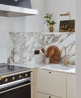 kitchen with cream units and marble backsplash