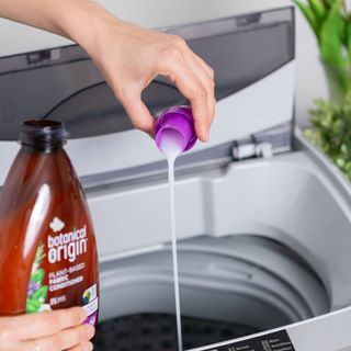 No Revisions / Unsplash pouring detergent into washing machine drum