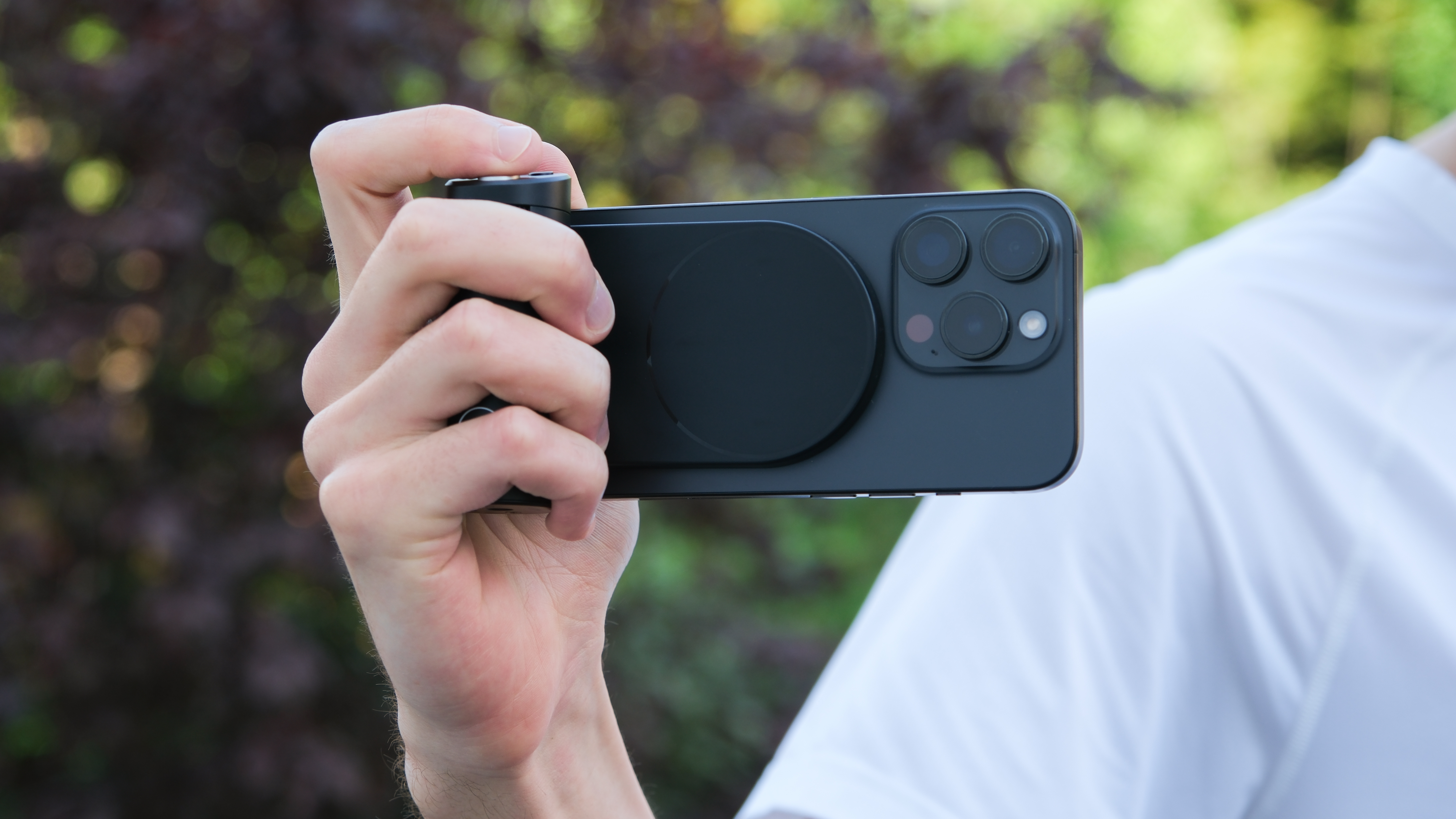 Leica Lux Grip attached to an iPhone and held in a hand