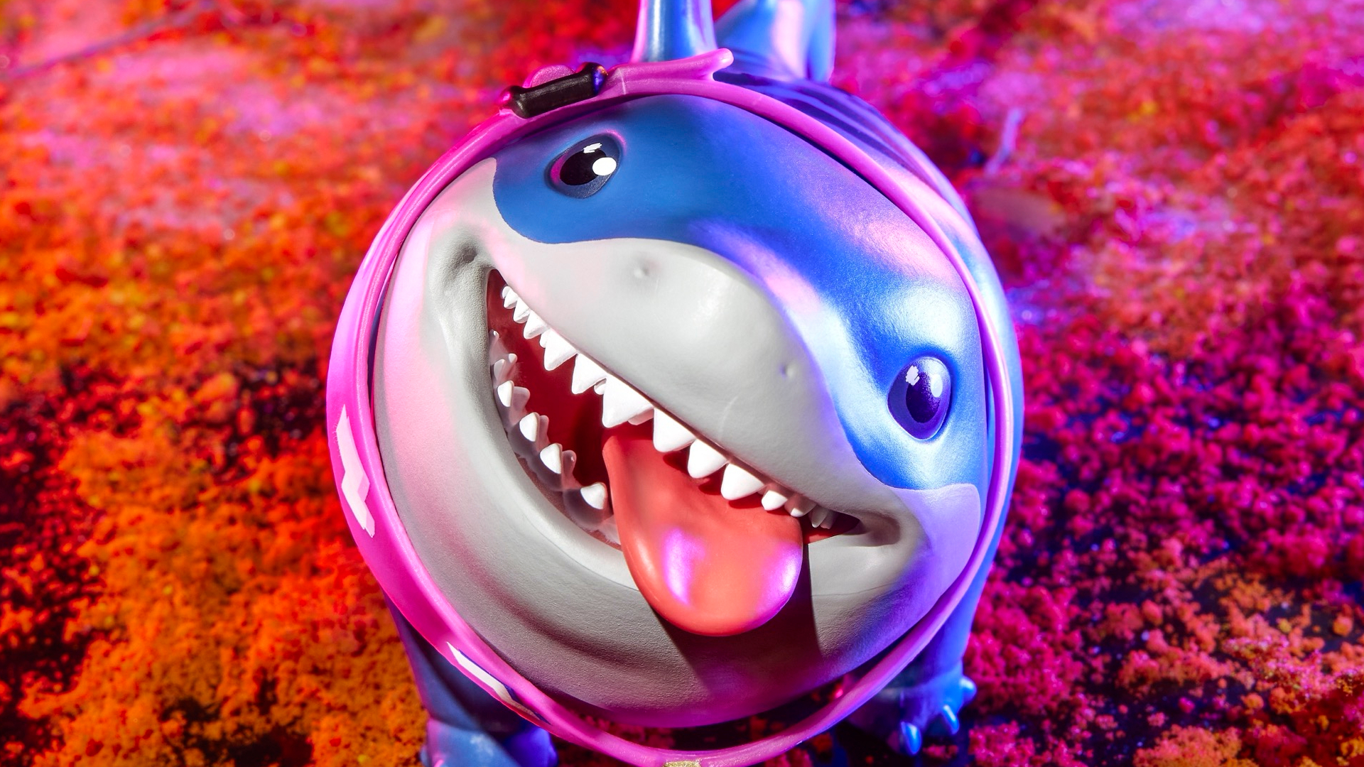 Jeff the Land Shark action figure smiling up into the foreground, with his tongue sticking out