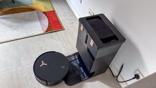 A top-down view of the Ecovacs Deebot X8 Pro Omni with the robot exiting the base station