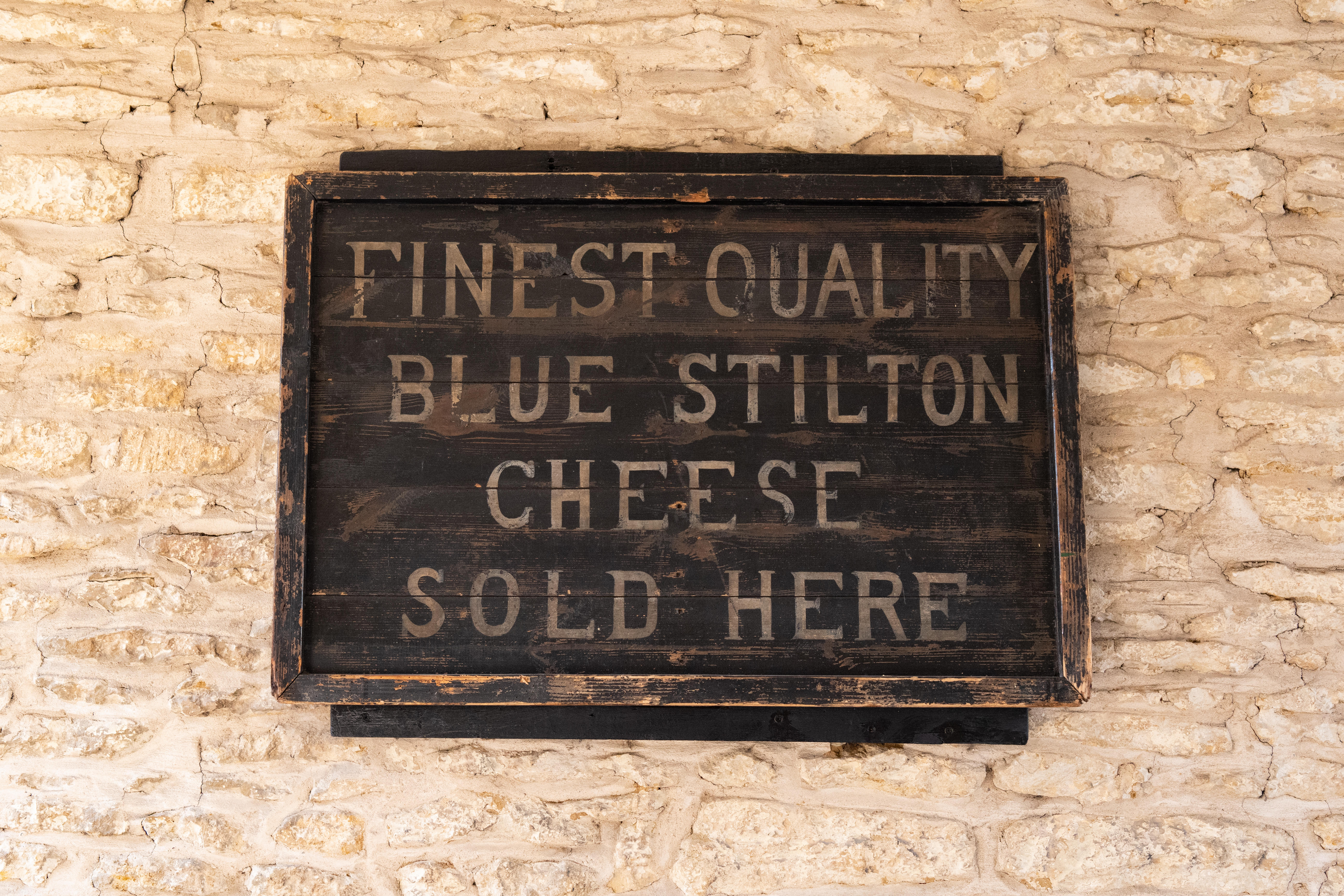 The Bell Inn Hotel, Stilton, Peterborough, England, UK - finest quality blue stilton cheese sold here sign