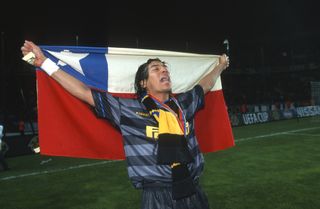 Ivan Zamorano celebrates with a Chilean flag after Inter's UEFA Cup final win over Lazio in May 1998.