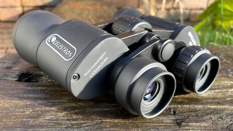 Celestron UpClose G2 10x50 binocular review: binoculars on a bench outside