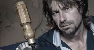 Patrick James Eggle is photographed in. his workshop with a vintage screwdriver in the foreground.