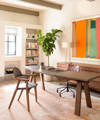 Home office with large bright artwork on the wall