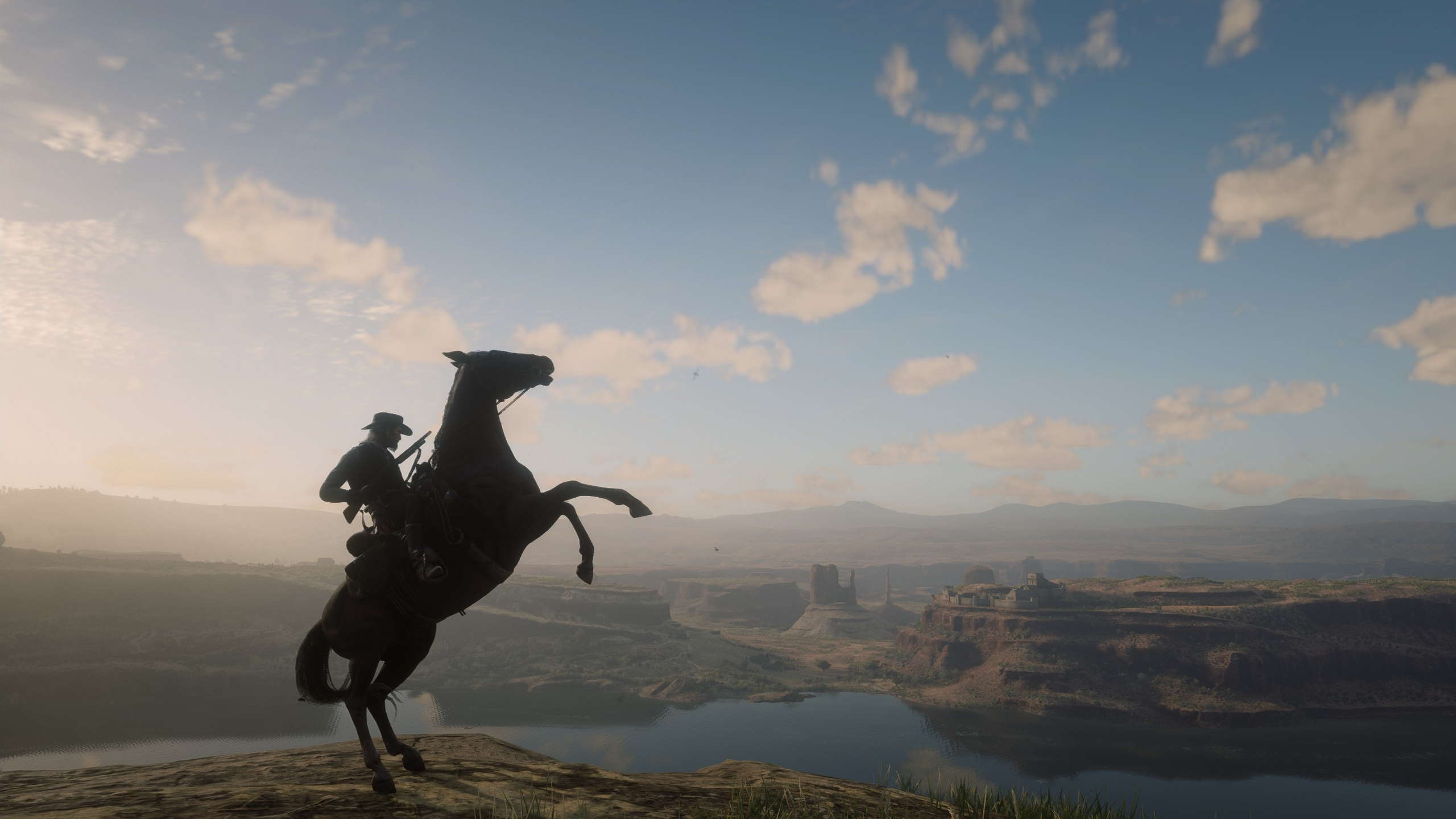 A beautiful vista in Red Dead Redemption 2 with a horse in the foreground