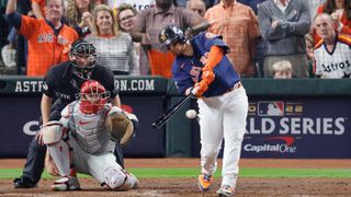 Christian Vazquez #9 of the Houston Astros hits a RBI single against the Philadelphia Phillies during the sixth inning in Game Six of the 2022 World Series at Minute Maid Park on November 05, 2022 in Houston, Texas.