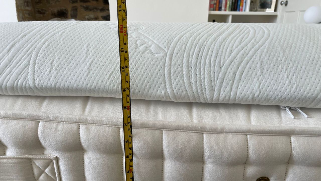 A tape measure showing the depth of the TheraPur ActiGel Cool Mattress Topper