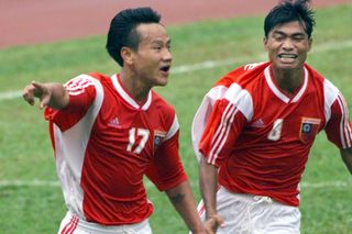 Aung Kyaw Tun (left) celebrates a goal for Myanmar's Under-23 team in September 2001.