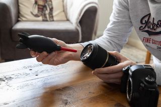 Using a dust blower to clean a Canon lens