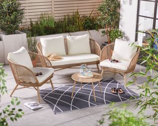 rope effect coffee set with sofa, chairs and table set on an outdoor rug