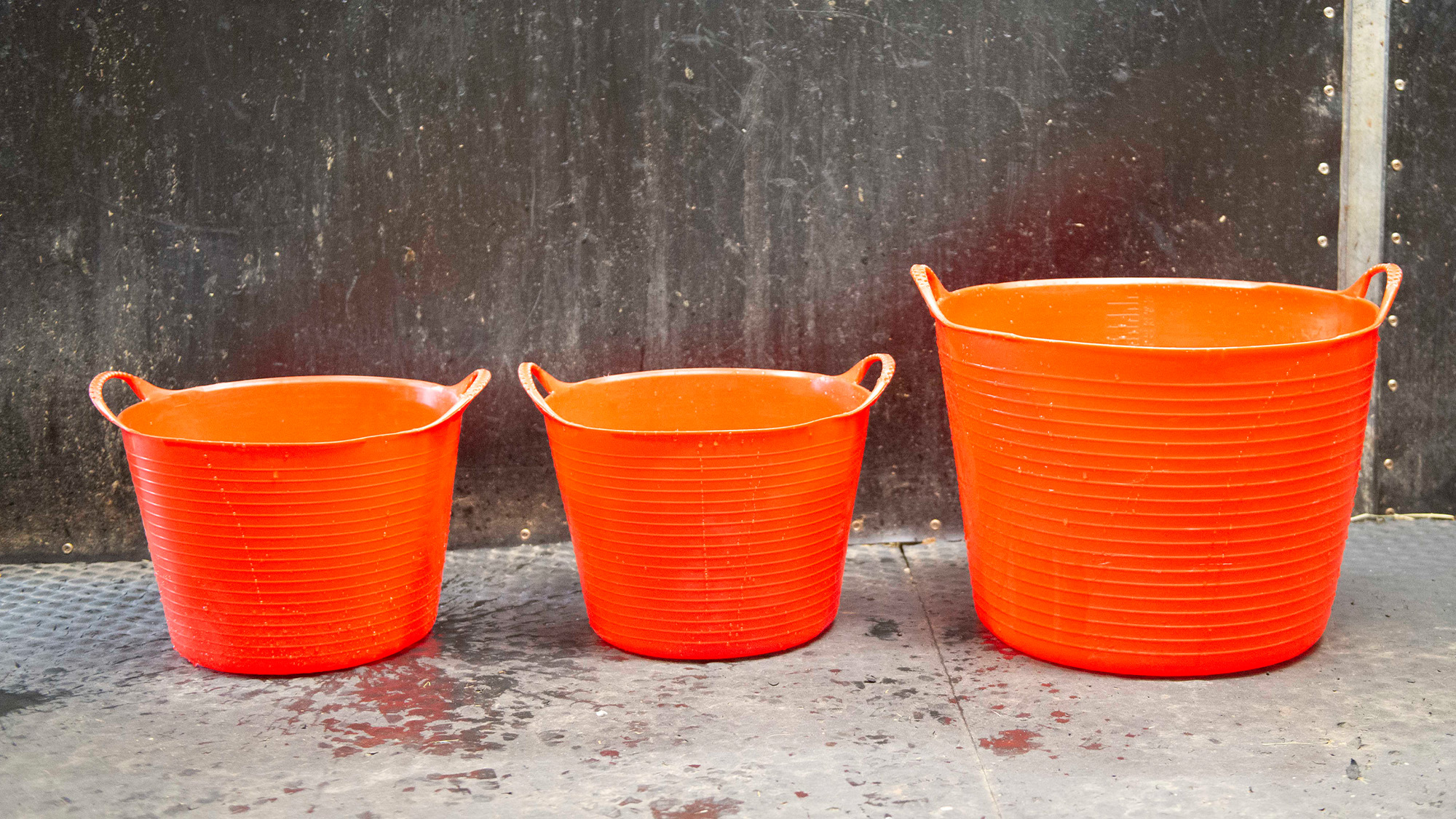 Three orange water buckets