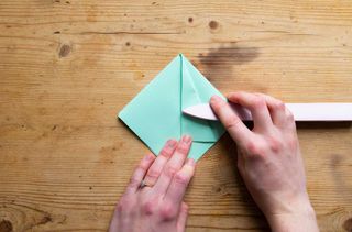 Making an origami shape out of green paper