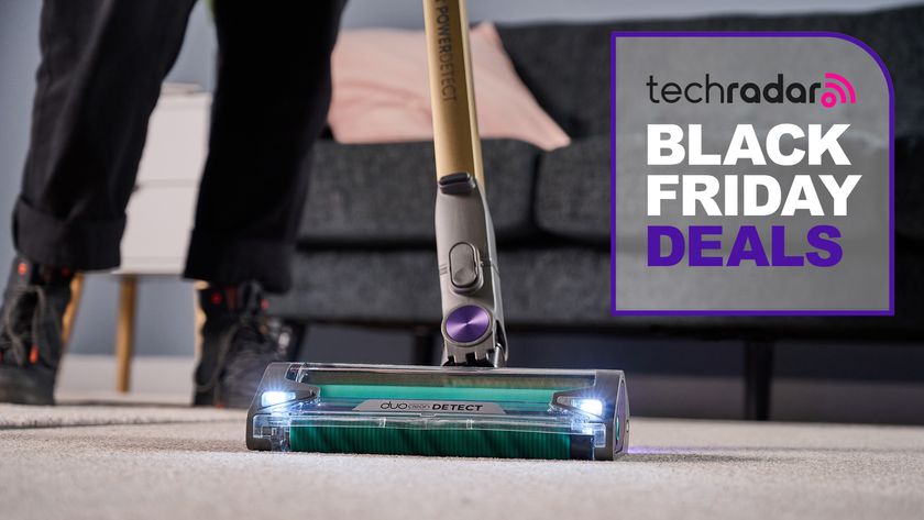 Person using Shark PowerDetect Vacuum, with Black Friday deals graphic alongside