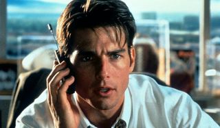 Jerry Maguire makes a phone call at his desk