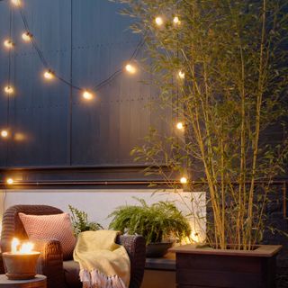 outdoor wall lighting with trees and sofa