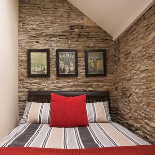 guest bedroom with stone walls