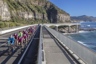 Riders on the Sea Cliff Bridge in Australia, which will form a part of the course for the women's and men's elite road races at the 2022 UCI Road World Championships