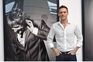 Bryan Adams with one of his portraits of Rod Stewart.