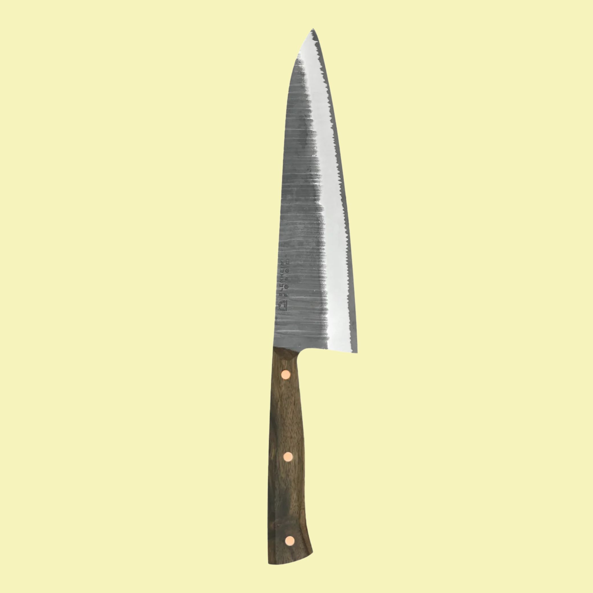 Blenheim Forge Full Tang Gyuto Knife against pale yellow background.