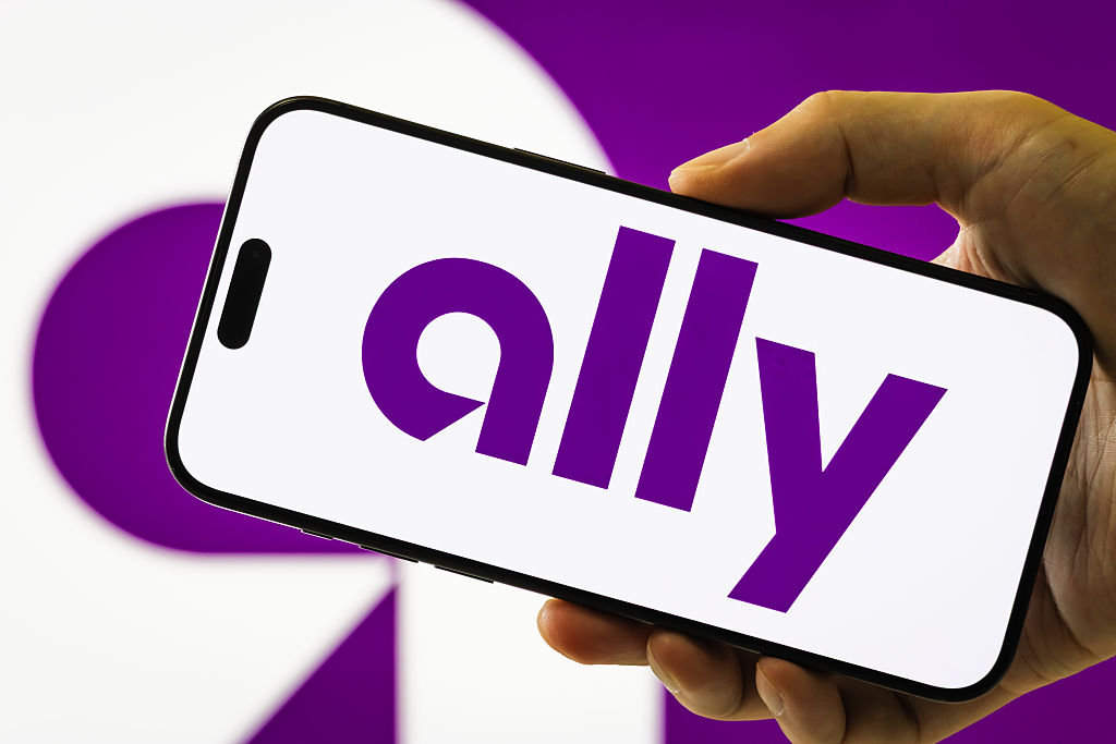 A smartphone held in a hand displays the logo of Ally Financial Inc.
