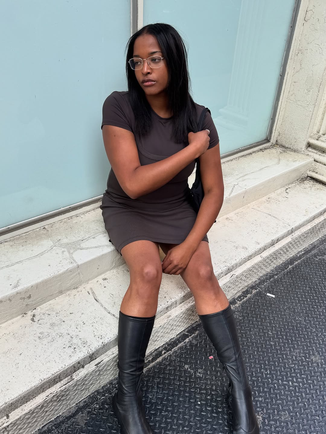 Woman wearing a minidress and tall boots.