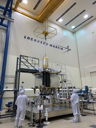 Engineers at work on the Lucy spacecraft in advance of its launch attach a propellant tank to the vehicle.