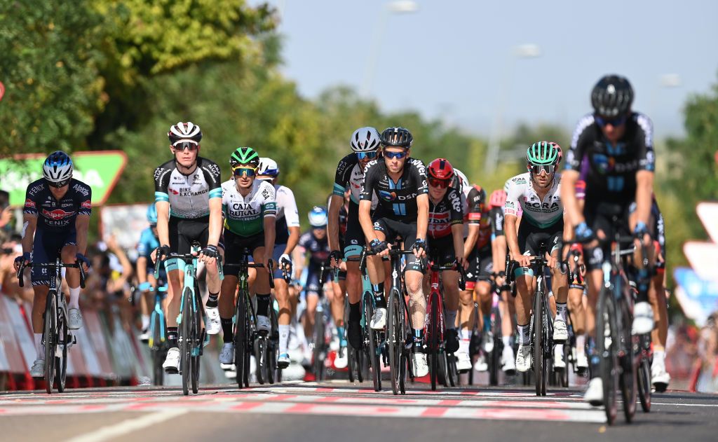 VILLANUEVA DE LA SERENA SPAIN AUGUST 27 LR Scott Thwaites of United Kingdom and Team AlpecinFenix Nicholas Schultz of Australia and Team BikeExchange Martijn Tusveld of the Netherlands and Team DSM Ben Zwiehoff of Germany and Team Bora Hansgrohe and the peloton cross the finishing line during the 76th Tour of Spain 2021 Stage 13 a 2037km stage from Belmez to Villanueva de la Serena lavuelta LaVuelta21 on August 27 2021 in Villanueva de la Serena Spain Photo by Stuart FranklinGetty Images