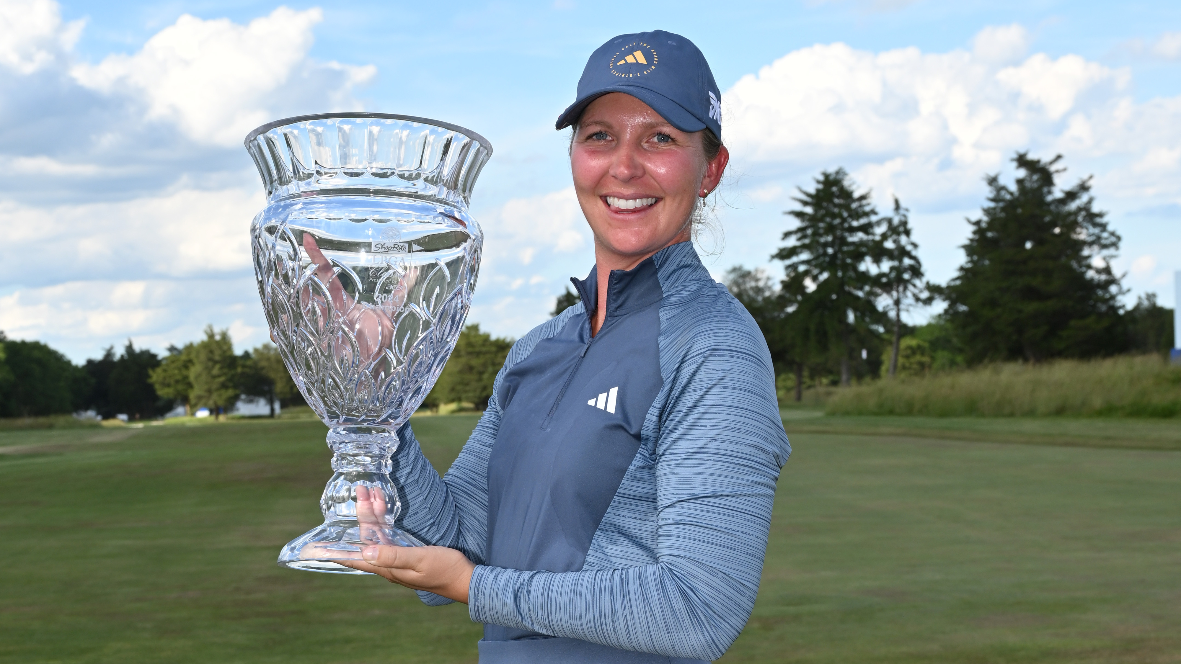 Linnea Storm smiling whilst holding the trophy after winning last years event