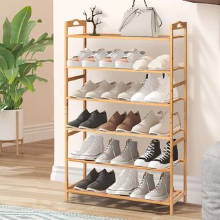 Bamboo shoe rack with shoes in entryway