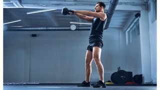 Person performing a kettlebell swing with arms extended in front