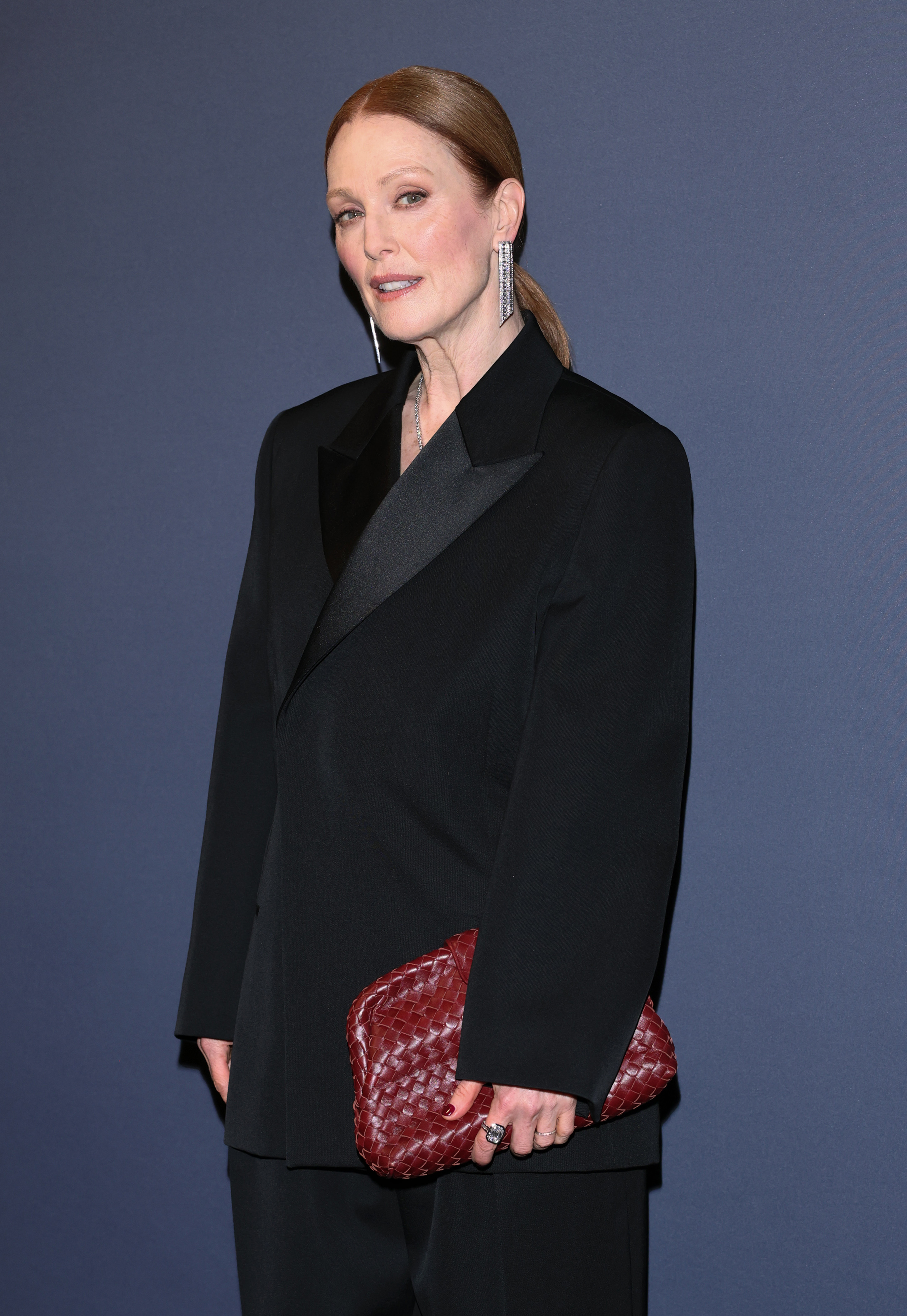 Julianne Moore attends the Kering Women in Motion event in a black Bottega Veneta suit and a woven clutch.