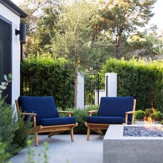 a backyard with two chairs