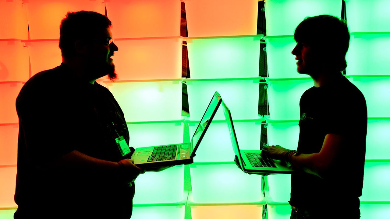 Men holding laptops