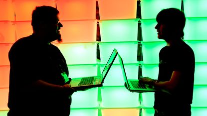 Men holding laptops