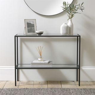 Black framed console table in neutral hallway
