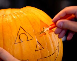 carving a pumpkin for Halloween