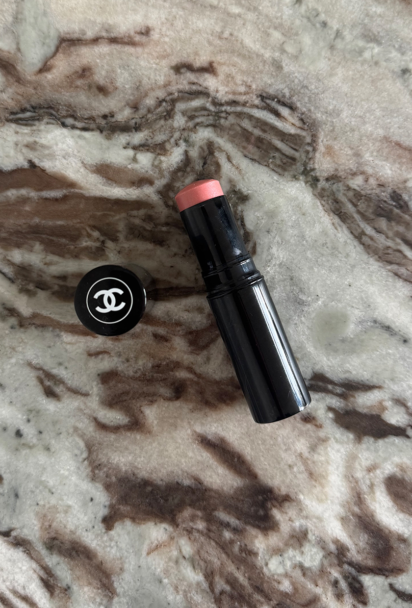 Chanel Baume Essentiel highlighter stick on marble background