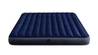 A blue inflatable air mattress placed on the floor