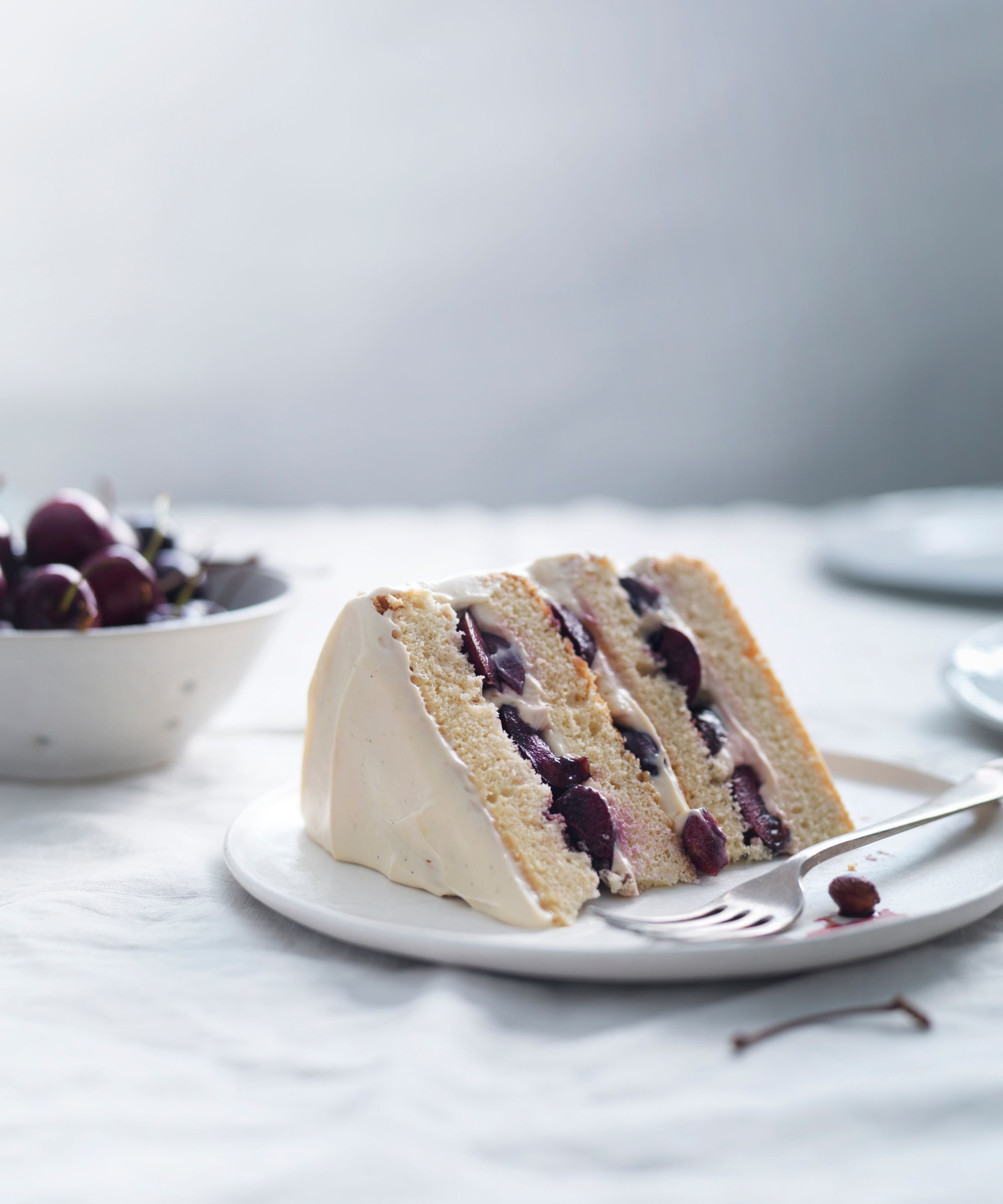 Slice of layered cherry cake on a plate