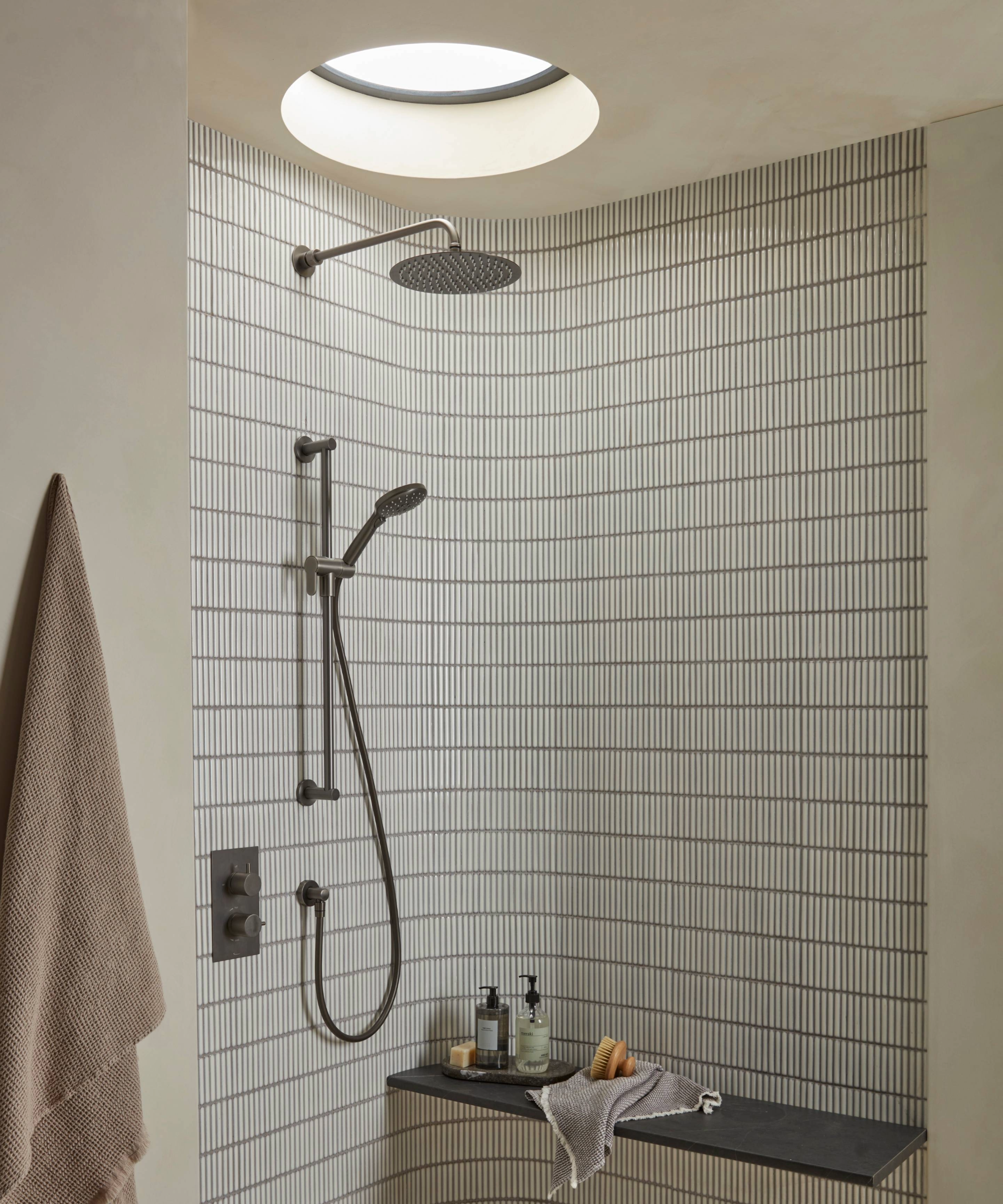 Wet room with tiled wall and circle sky light