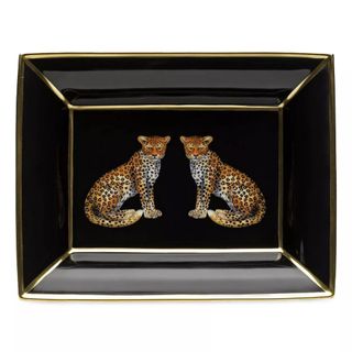 A black decorative tray with gold lining and two leopards