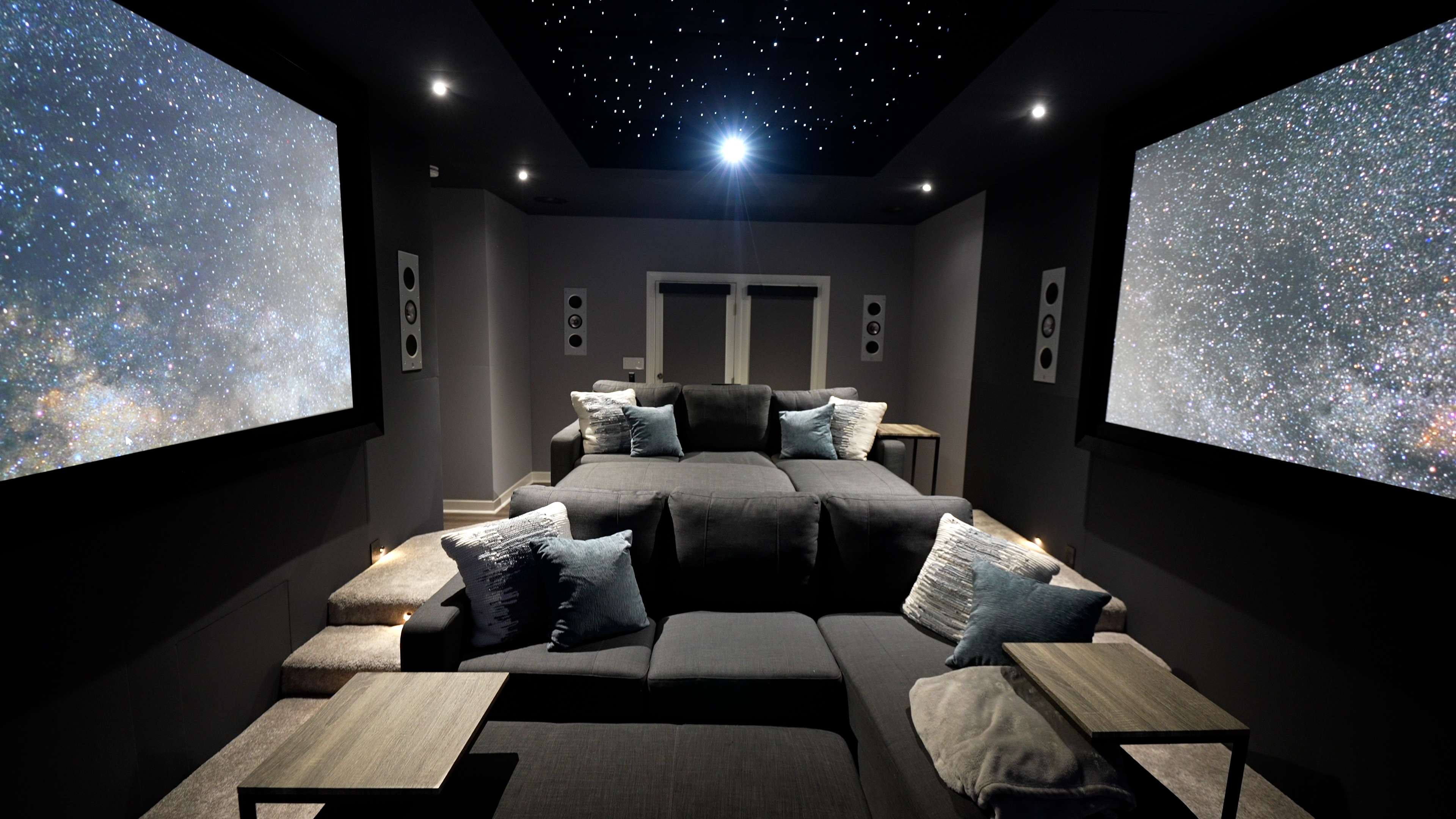 images of The Ultimate Home Theater Gaming Setup theater showing three projection screens, sofas and gaming peripherals
