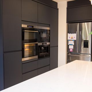 kitchen with grey cabinet white flooring and kitchen storage