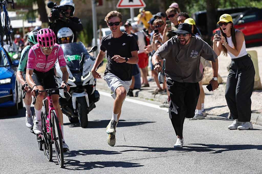 Spectators run alongside EF Education - EasyPost team's French rider Alex Baudin and Decathlon CMA CGM Team's French rider Nicolas Prodhomme as they cycle in a breakaway during the 3rd stage of the 113th edition of the Tour de France cycling race, 195,9 km between Granollers in Spain and Les Angles in southern France, on July 6, 2026. (Photo by Anne-Christine POUJOULAT / AFP)