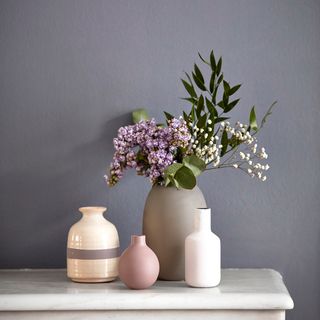 grey wall with flower pot and various shape pots