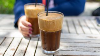 Two glasses of frappe coffee on a table